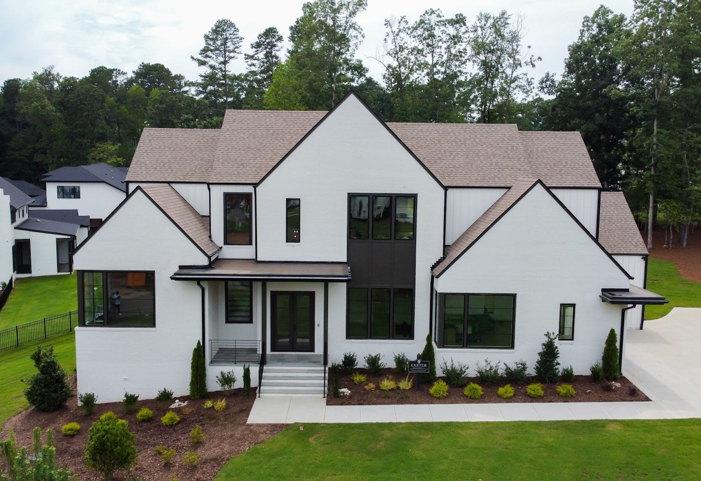 Modern farmhouse exterior — White siding, black windows